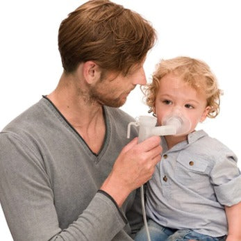 an elderly man using a nebuliser